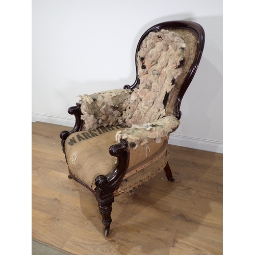 28 - A Victorian mahogany framed spoon back Armchair in need of re-upholstery