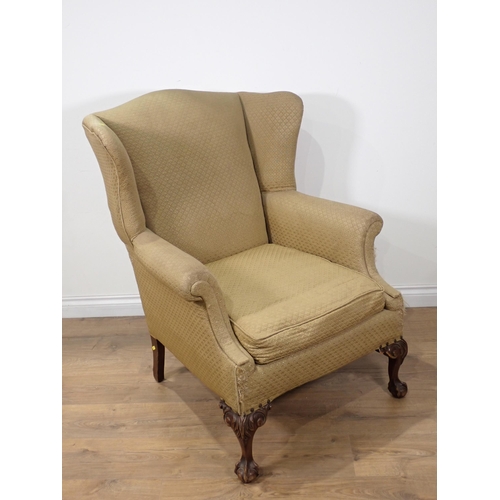 29 - A Georgian style wingback Armchair on mahogany carved claw and ball front supports