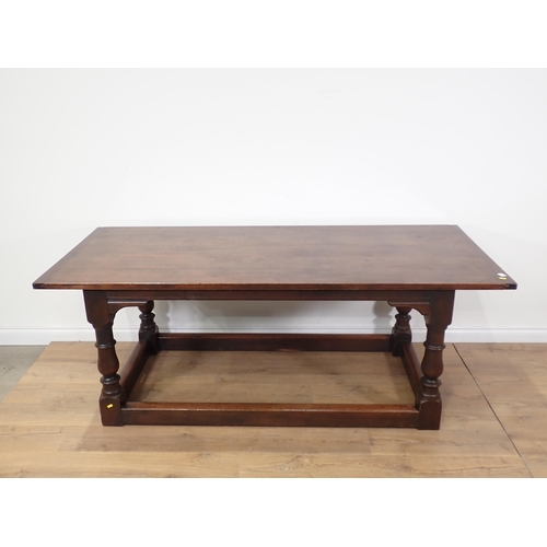 92 - An oak Refectory Table in the 17th Century style on baluster turned supports with surrounding stretc... 