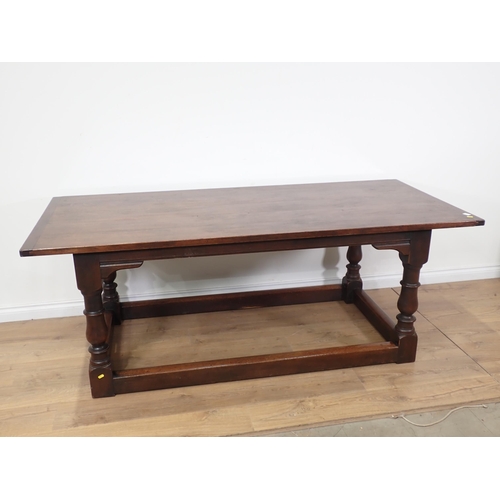 92 - An oak Refectory Table in the 17th Century style on baluster turned supports with surrounding stretc... 