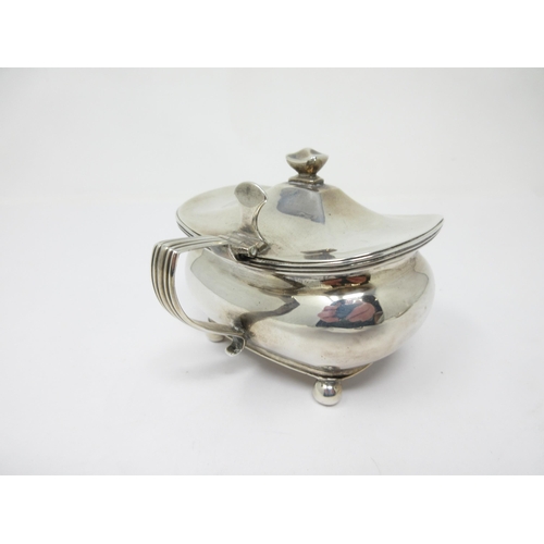10 - A George III silver Mustard Pot with hinged lid, reeded handle on ball feet, London 1810, maker: Tho... 