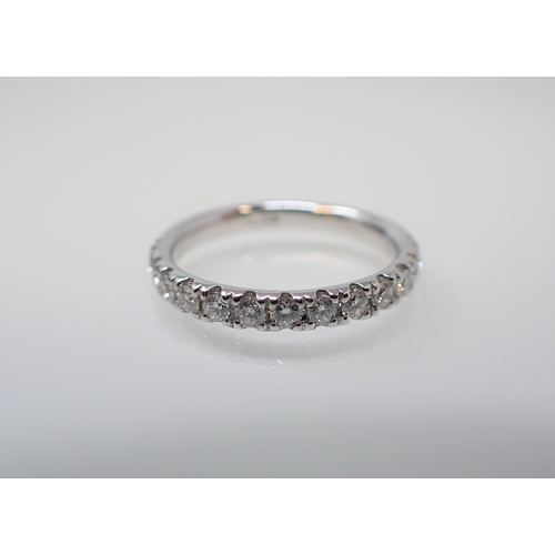 143 - A Diamond half Eternity Ring pavé-set brilliant-cut stones in 18ct white gold, ring size K