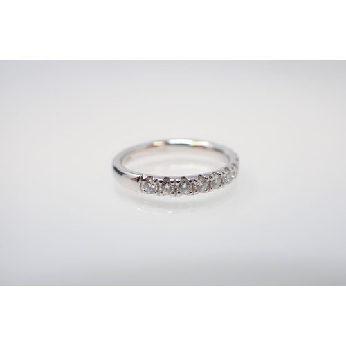 143 - A Diamond half Eternity Ring pavé-set brilliant-cut stones in 18ct white gold, ring size K