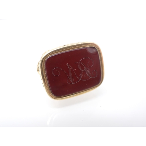 147 - An ornate Seal Fob embossed fruiting vine set carnelian engraved monogram, approx 20.9gms