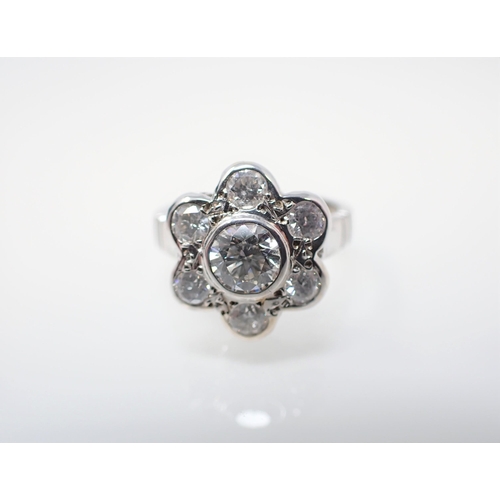 152 - A Diamond Daisy Cluster Ring rubover-set brilliant-cut stone, 0.74cts, within frame of six smaller s... 