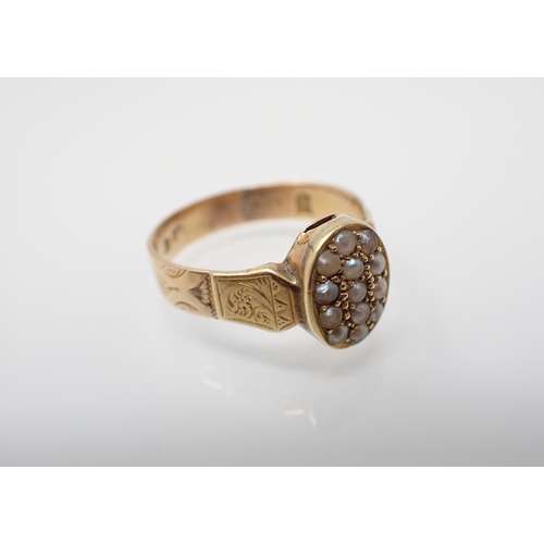 157 - A 19th Century Seed Pearl Ring having oval plaque set pearls, engraving to shoulders and shank in 18... 