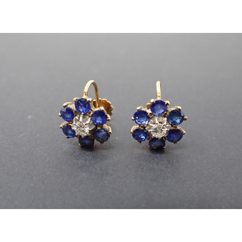 163 - A pair of Flower Cluster Earrings each claw-set brilliant-cut diamond within a frame of six round bl... 