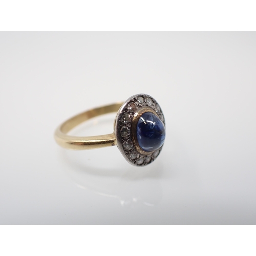 166 - A 1960's Sapphire and Diamond Cluster Ring rubover-set oval cabochon sapphire within a frame of pavé... 