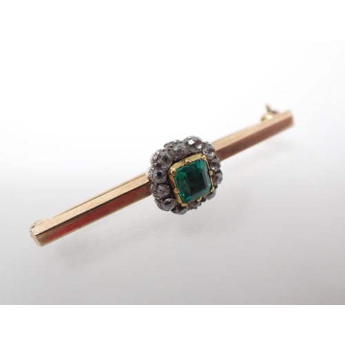 167 - An Emerald and Diamond Brooch set foil backed cushion-cut emerald within a frame of close-set old-cu... 