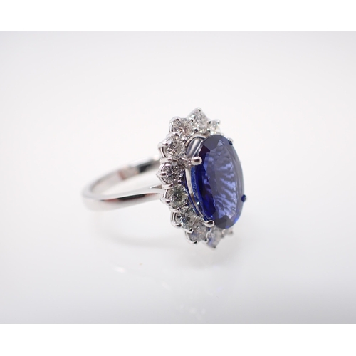 174 - A Sapphire and Diamond Cluster Ring claw-set oval-cut sapphire, 4.02cts, within a frame of fourteen ... 