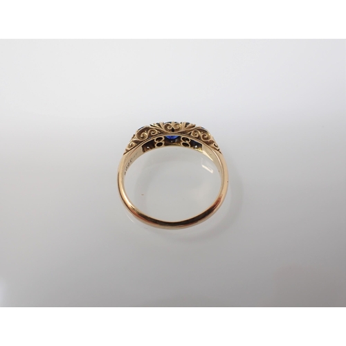 183 - A Sapphire and Diamond Ring pavé-set three cushion cut sapphires interspersed with pairs of old-cut ... 