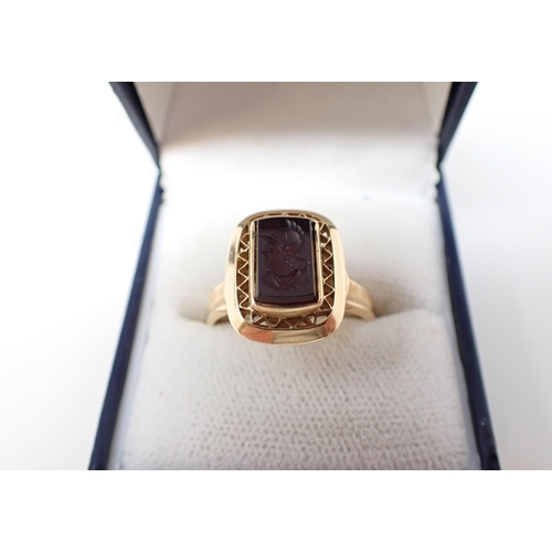 193 - An Intaglio Ring the black onyx carved Mercury in pierced mount, stamped 750, ring size T 1/2, appro... 