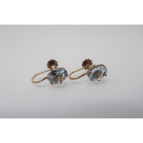 200 - A pair of Aquamarine Earrings each claw-set oval-cut stone on screw fittings stamped 375.