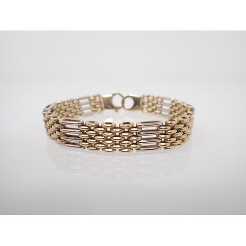 207 - A 9ct white and yellow gold gatelink Bracelet, approx 19.80gms