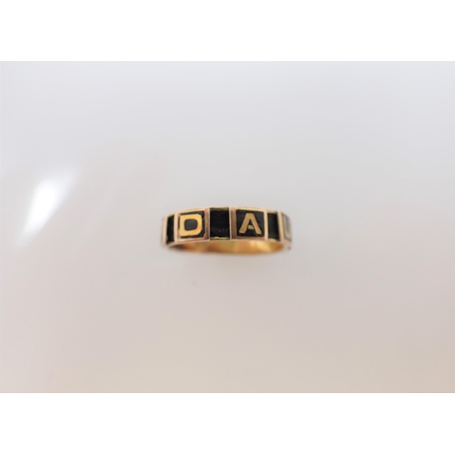 218 - An 18ct gold memoriam Ring  having black enamel panels spelling 'DAUGHTER' interspersed with panels ... 