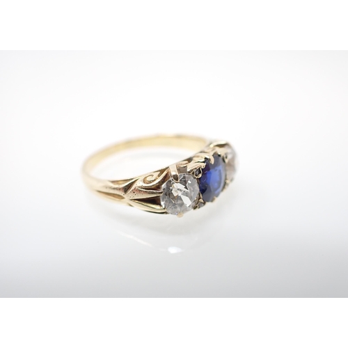 220 - A Sapphire and Diamond three stone Ring claw-set cushion-cut sapphire between two old-cut diamonds, ... 