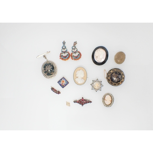 255 - A collection of Brooches including; lava cameo, carved shell cameo, moss agate, garnet, piqué etc