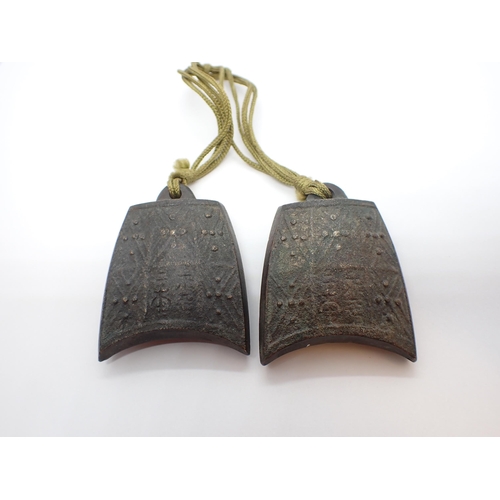 273 - A pair of bronze Weights in the shape of temple bells embossed geometric design, 1 3/4in x 2in