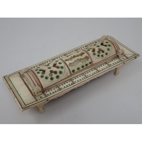 277 - A carved bone Cribbage Board with pierced domed cover containing dominoes and dice, possibly prisone... 