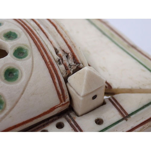 277 - A carved bone Cribbage Board with pierced domed cover containing dominoes and dice, possibly prisone... 