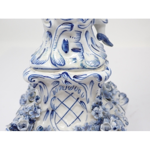 332 - A pair of Dresden blue and white Table Candelabra with floral encrusted arms and leafage sconces sup... 