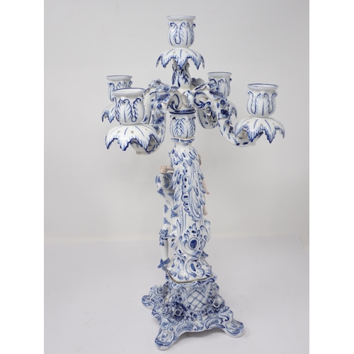 332 - A pair of Dresden blue and white Table Candelabra with floral encrusted arms and leafage sconces sup... 