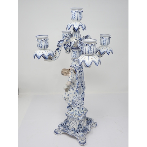 332 - A pair of Dresden blue and white Table Candelabra with floral encrusted arms and leafage sconces sup... 