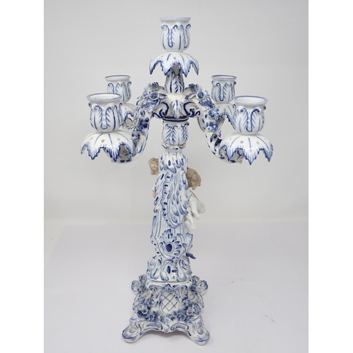 332 - A pair of Dresden blue and white Table Candelabra with floral encrusted arms and leafage sconces sup... 