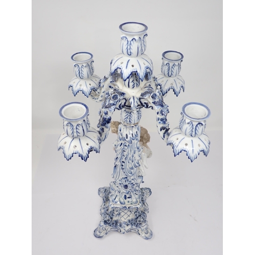 332 - A pair of Dresden blue and white Table Candelabra with floral encrusted arms and leafage sconces sup... 