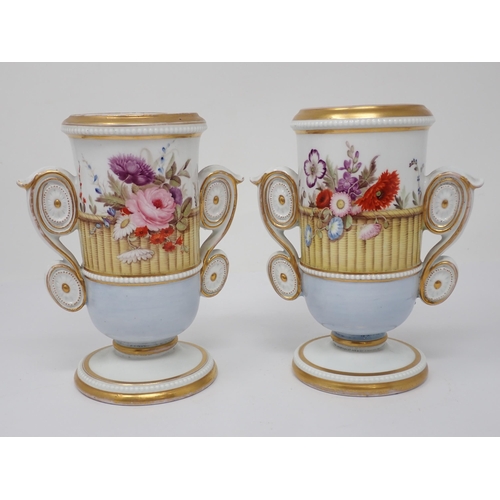 357 - A pair of 19th Century Vases with moulded scroll handles painted flowers in a basket, pale blue to l... 