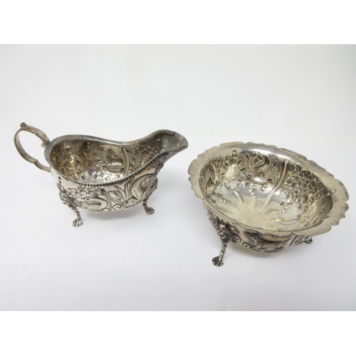 36 - An Edward VII Irish silver Jug and Sugar Bowl embossed birds, dolphins and animals on lion mask supp... 