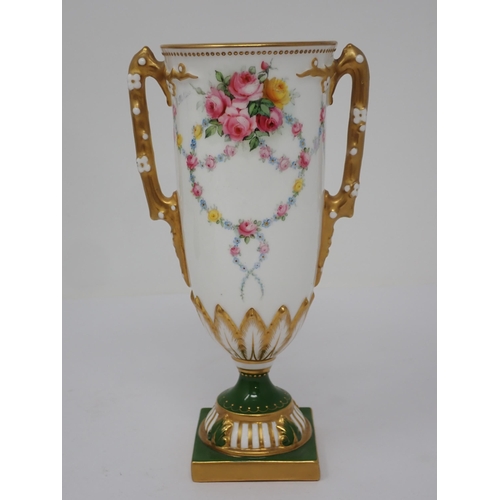 362 - A Royal Worcester two handled Vase with floral garlands, gilt branch handle on stepped base, two por... 