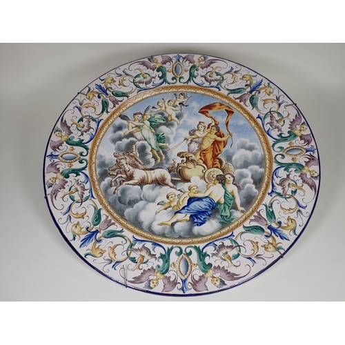 370 - A large pair of Italian Majolica Chargers, central panels of allegorical figures, on chariot, angels... 