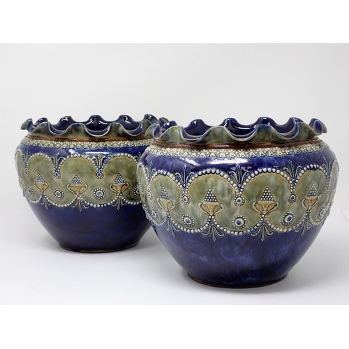 384 - A pair of Royal Doulton Jardinieres with floral rims and raised moulded bands of decoration, 9in dia... 