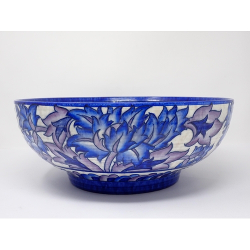 386 - A Charlotte Rhead large Bowl and matching tapering Jug, decorated stylised flowers in blue and purpl... 