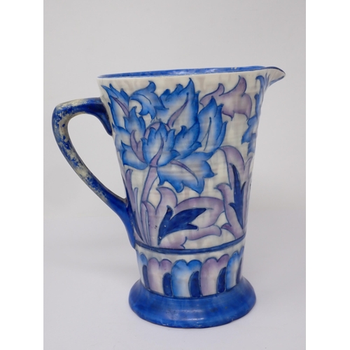 386 - A Charlotte Rhead large Bowl and matching tapering Jug, decorated stylised flowers in blue and purpl... 