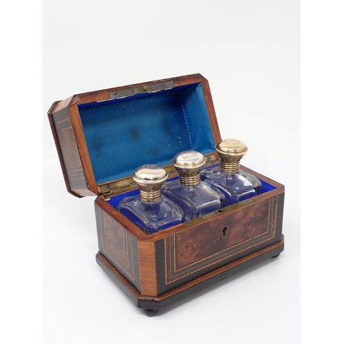 388 - A burr wood and brass inlaid scent bottle Box the lined interior containing three plated mounted Sce... 