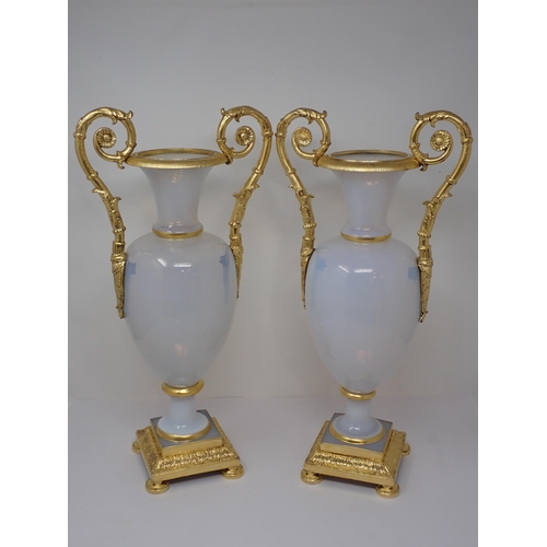 405 - An impressive pair of opaline glass baluster Vases on square plinth, having gilded ormolu mounts to ... 