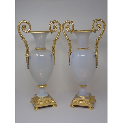 405 - An impressive pair of opaline glass baluster Vases on square plinth, having gilded ormolu mounts to ... 