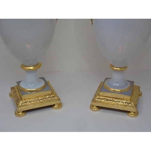 405 - An impressive pair of opaline glass baluster Vases on square plinth, having gilded ormolu mounts to ... 