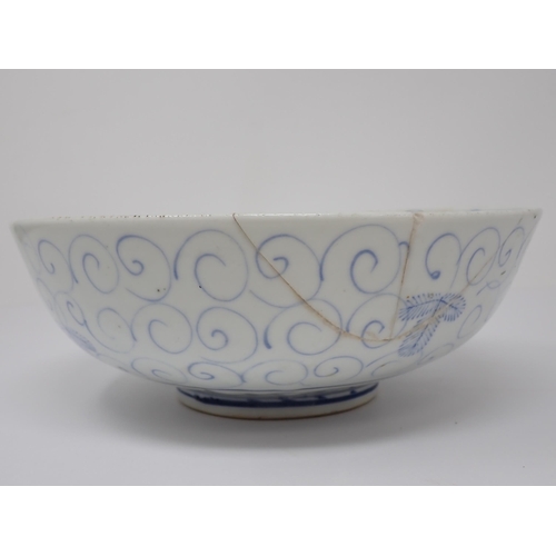 411 - An 18th Century blue and white Chinese Bowl decorated in a leaf and scroll pattern, 8in W, A/F