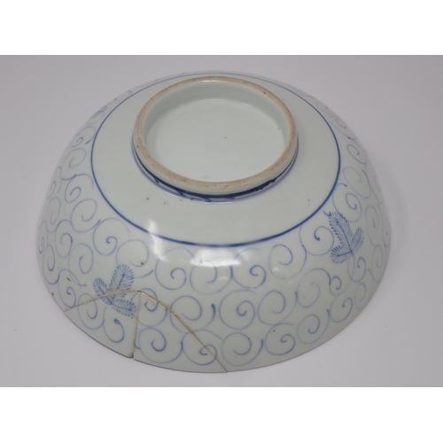 411 - An 18th Century blue and white Chinese Bowl decorated in a leaf and scroll pattern, 8in W, A/F