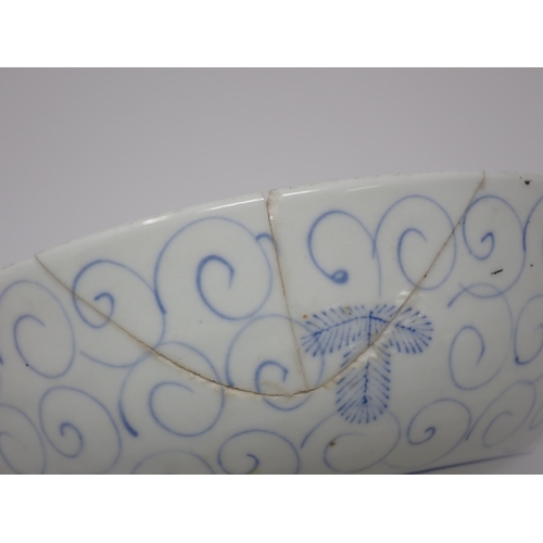 411 - An 18th Century blue and white Chinese Bowl decorated in a leaf and scroll pattern, 8in W, A/F