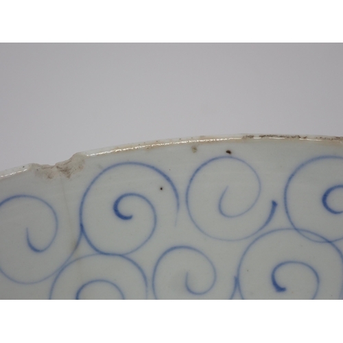 411 - An 18th Century blue and white Chinese Bowl decorated in a leaf and scroll pattern, 8in W, A/F