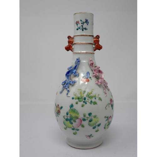 415 - A Chinese famille rose bottle Vase painted fruit and flowers with applied pair of pink and blue liza... 