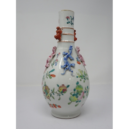 415 - A Chinese famille rose bottle Vase painted fruit and flowers with applied pair of pink and blue liza... 