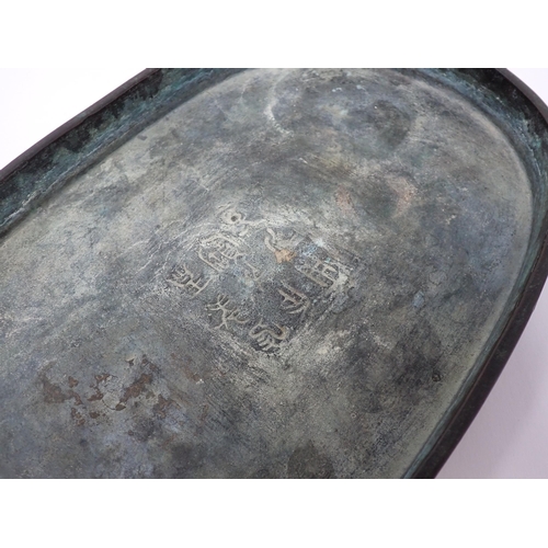 428 - A Chinese shallow metal oval Dish, possibly for narcissus bulbs, outer side embossed good luck symbo... 