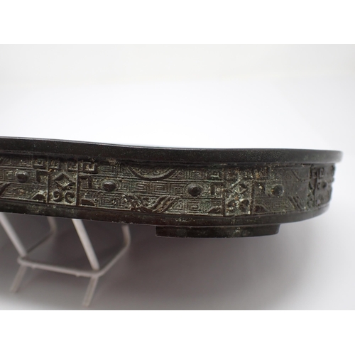 428 - A Chinese shallow metal oval Dish, possibly for narcissus bulbs, outer side embossed good luck symbo... 