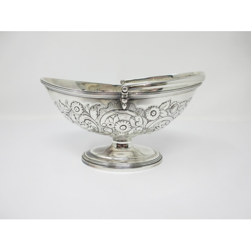 42A - A George III silver oval Basket with later floral embossing, swing handle on pedestal base, London 1... 