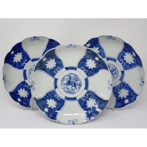 431 - A set of three Chinese blue and white Dishes decorated alternating panels with dragons to the centre... 